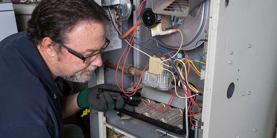 Technician installing heating system