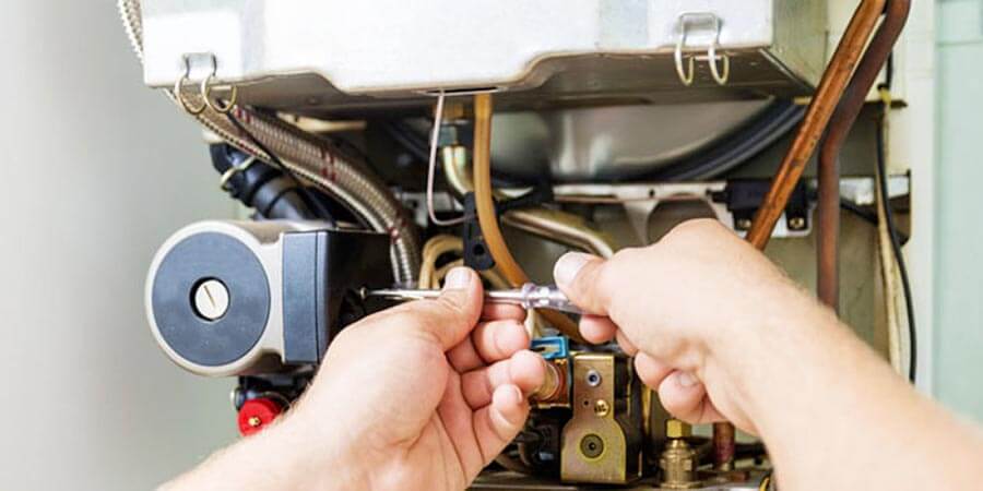 Technician with tools fixing heating