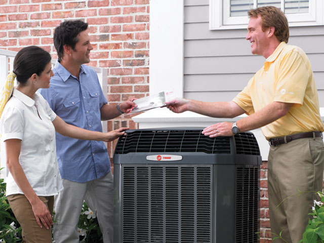 Technician handing over paperwork to homeowners