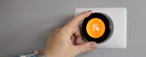 Man Is Adjusting A Temperature In Modern Living Room